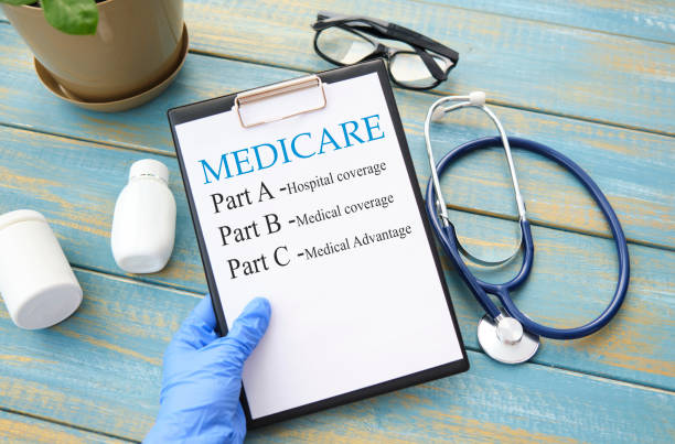 Stethoscope with medicare form with parts list in hand. Stethoscope with medicare form with parts list in hand. medicare stock pictures, royalty-free photos & images