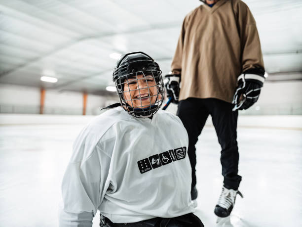 istock Latin woman and her trainer practising sledge hockey 1362756574