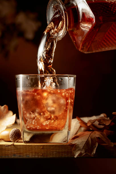 istock Whiskey is poured into a glass with ice. 1362757554