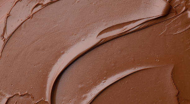 melted chocolate background melted chocolate cream background, top view cake-toppings stock pictures, royalty-free photos & images