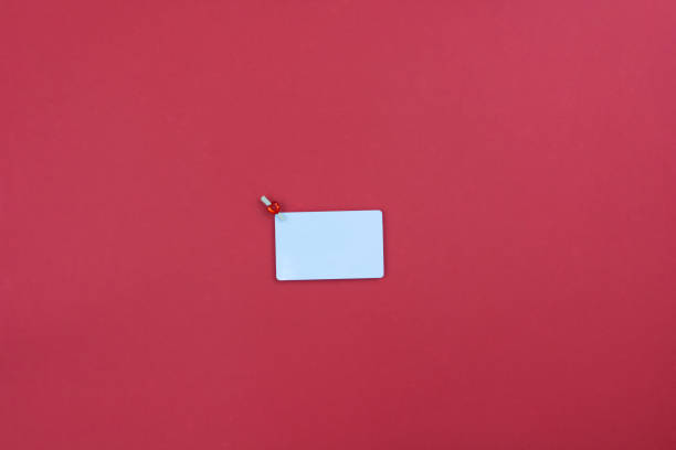 istock White card on red background. Copy space. Place for text. Minimalism. 1362759035