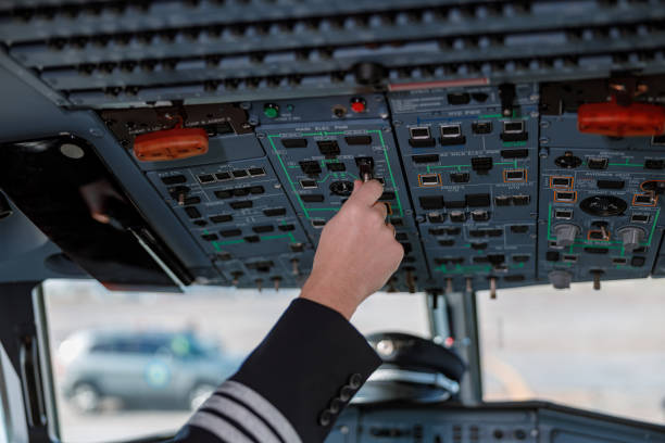 istock Aircraft pilot operating overhead panel of airplane flight deck 1362759275