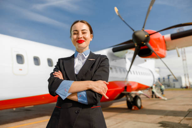 istock Joyful woman stewardess standing outdoors at airfield 1362759287