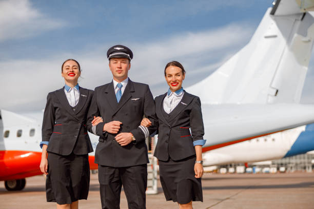 istock Aircraft pilot and flight attendants standing outdoors at airfield 1362759325