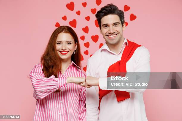 Young Smiling Couple Two Friends Woman Man 20s In Casual Shirt Look Camera Do Fistbump Gesture Isolated On Plain Pastel Pink Background Studio Portrait Valentines Day Birthday Holiday Party Concept Stock Photo - Download Image Now