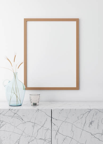 istock Empty vertical picture frame on white wall in modern living room. Mock up interior in minimalist, scandinavian style. Free space for picture. Marble console and dried grass in glass vase. 3D rendering 1362763630
