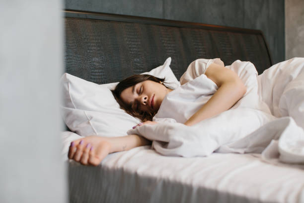 istock Woman sleeping in bed - stock photo 1362764061