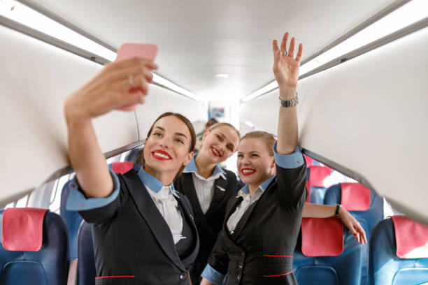 istock Cheerful women stewardesses making selfie in airplane 1362766140
