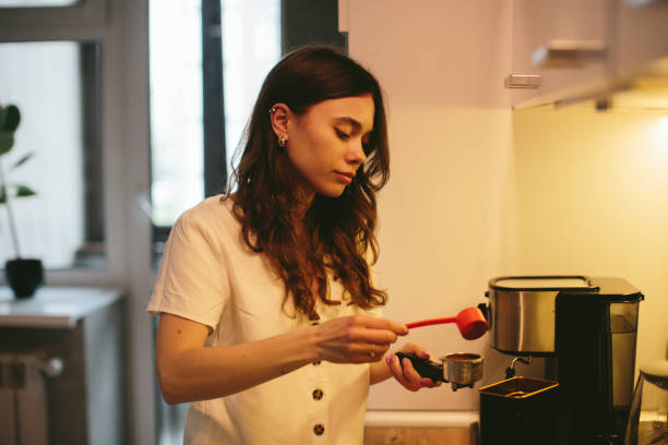istock Young woman making morning coffee in the kitchen. 1362768183
