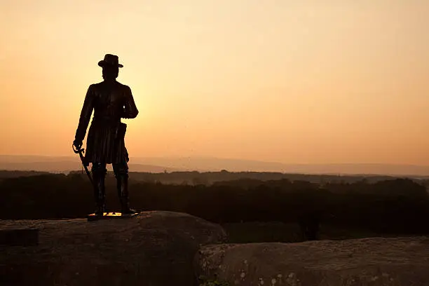 A sunset from Little Round Top at the Gettysburg National Military Park in Pennsylvania. The statue is of Union General Gouverneur K. Warren errected on August 8, 1888 and created by Karl Gerhardt.