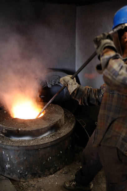 istock Foundry worker stirring molten metal 136277296