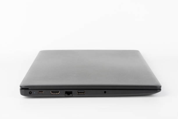 Modern, new office  black  laptop  on white background, side view. USB 2.0 port, RJ-45, HDMI port. stock photo