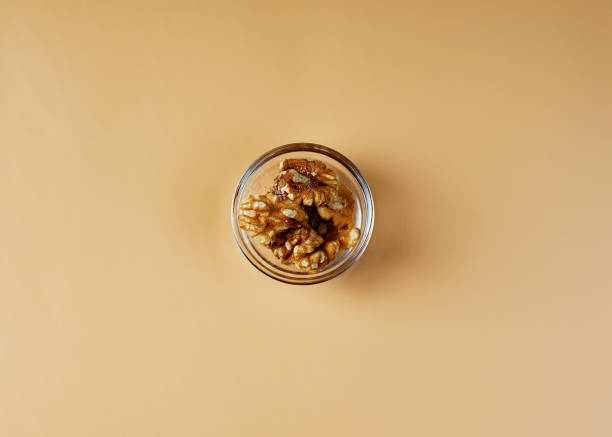 istock Bowl with walnuts on an orange background. Salad ingredients. 1362775853