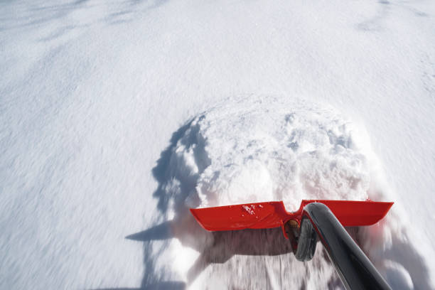 A first-person perspective of shoveling snow stock photo