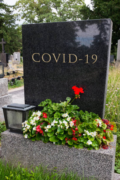 istock Graveyard tombstone with COVID-19 inscription epitaph 1362777863