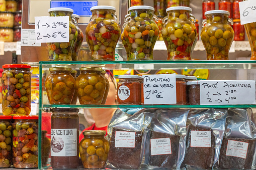Olives at Mercado Central (Central Market) in Valencia, Spain, with commercial stickers visible.