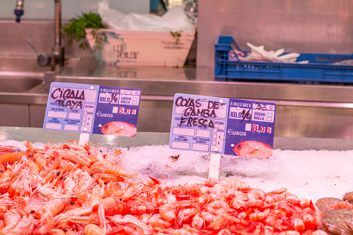 Shrimp Tails at Mercado Central (Central Market) in Valencia, Spain, with fish illustrations on the label