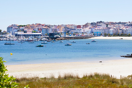 Baltar beach, Portonovo village townscape and harbor in the background. Sanxenxo, Rías Baixas , Ría de Pontevedra, Galicia, Spain.