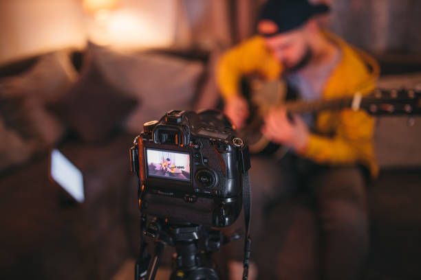 istock Young vlogger, guitarist filming his vlogg 1362785100