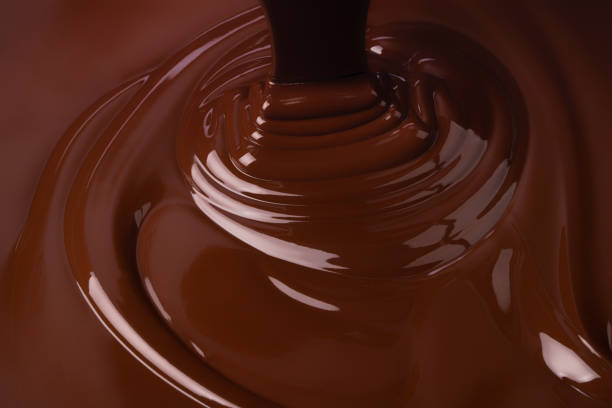 istock stream melt chocolate spreads in waves. hot cocoa background 1362786803