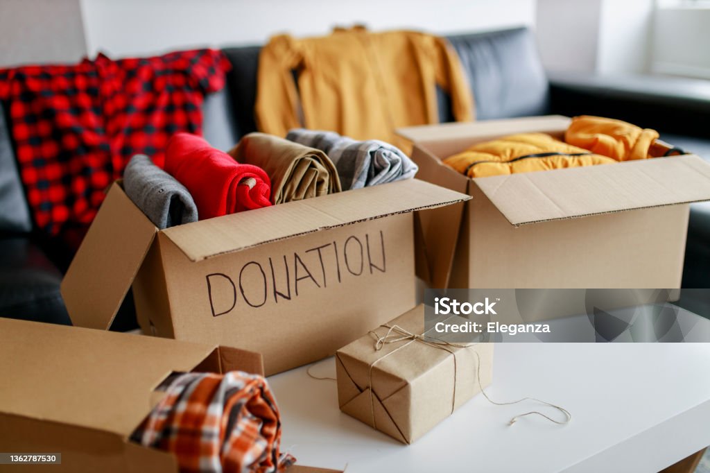 Donation box with stuff (blankets and clothes) Charitable Donation Stock Photo
