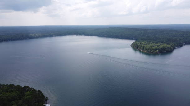 istock Beautiful lake scene with puffy clouds, as seen from a drone 1362787847