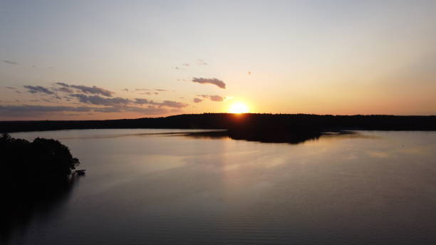istock Beautiful lake scene with puffy clouds, as seen from a drone in the evening 1362787849