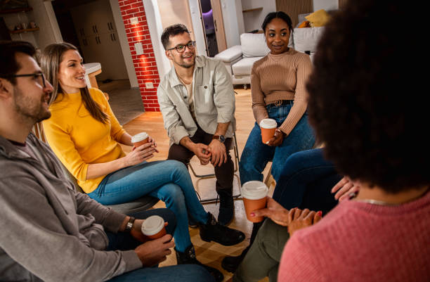 Diverse group of people sitting in circle in group therapy session. Diverse group of people sitting in circle in group therapy session. group therapy stock pictures, royalty-free photos & images