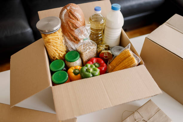 istock High angle view of a cardboard box filled with multicolored non-perishable canned goods, conserves, sauces and oils 1362789741