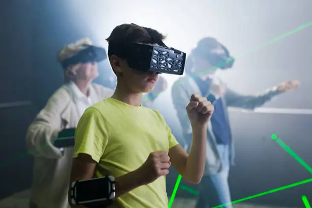 Photo of Family are wearing virtual reality goggles in quest room