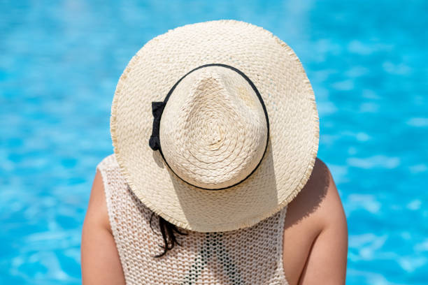 istock Girl with Straws hat on water background 1362792031