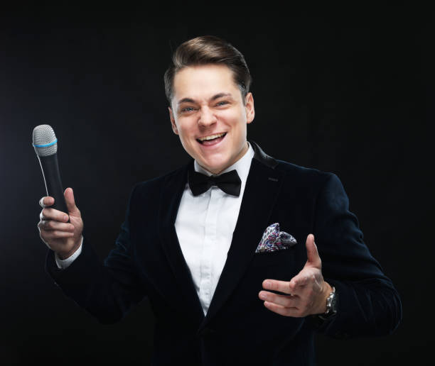 istock Young man in suit singing over the microphone with energy 1362794166