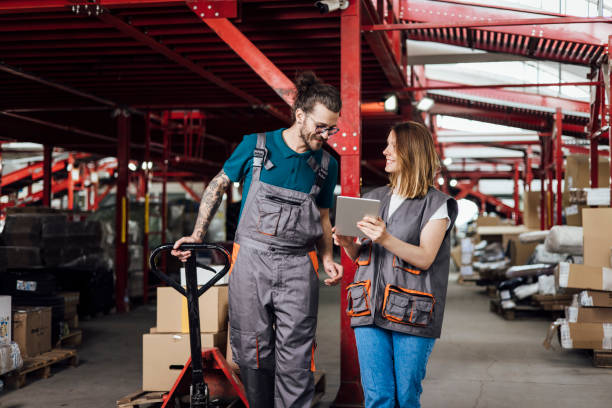 istock Young man and woman working at the warehouse on transporting boxes 1362807325