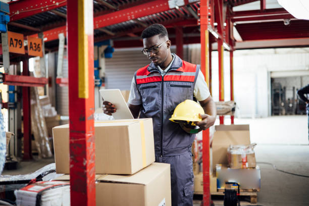 istock African American warehouse worker storing cardboard boxes 1362807338