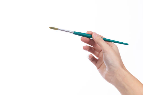 istock Art brush held in a lady's hand, on a white background 1362812114