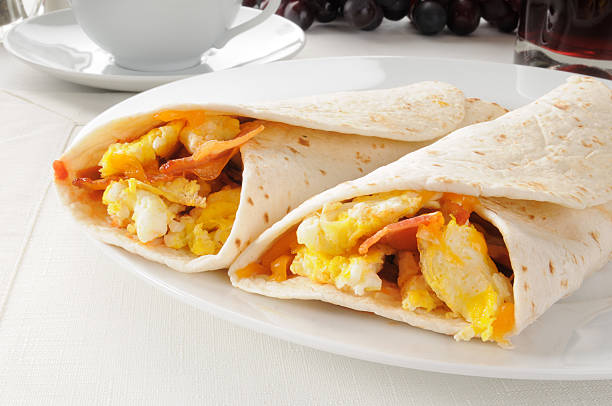 Bacon and egg burritos Two bacon and egg burritos with coffee burrito stock pictures, royalty-free photos & images