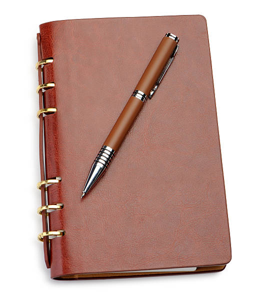istock Notebook in a brown leather cover and stylish pen 136281358