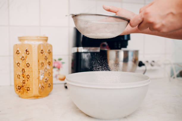 istock Pastry chef sift pours flour makes cake. Cooking and preparing dessert 1362814109