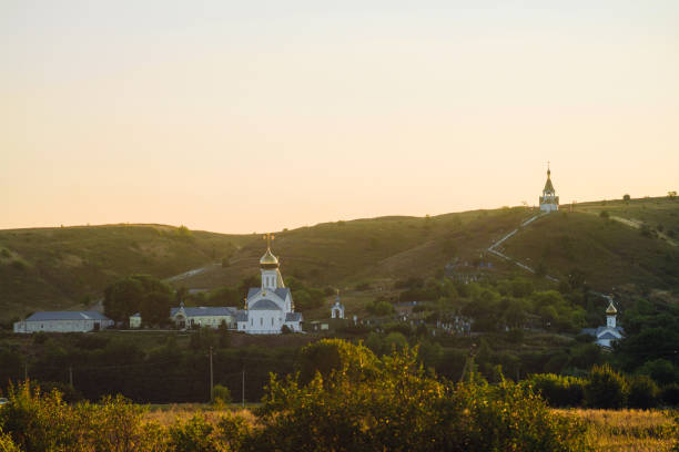 Orthodox Church of the Ascension of Christ on a high plateau on the Crimean Peninsula, surrounded by mountains. The background is partially obscured by fog