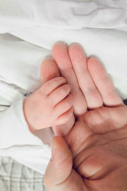 istock Newborn baby holding father finger 1362815855