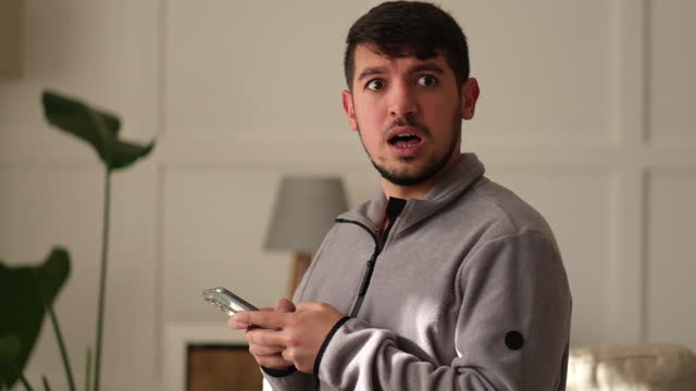 Man holding smartphone read unpleasant sms feels stressed