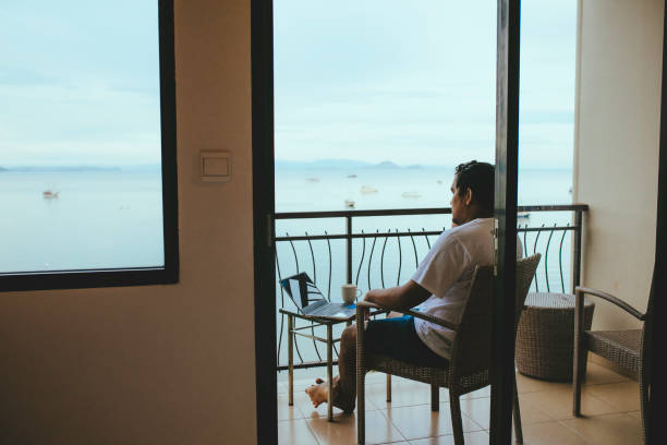 istock asian young man using laptop in balcony 1362827680