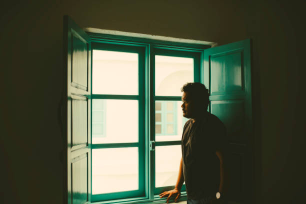 istock Asian taking In The View from His  Room 1362827723