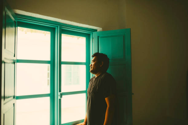 istock Asian taking In The View from His  Room 1362827732