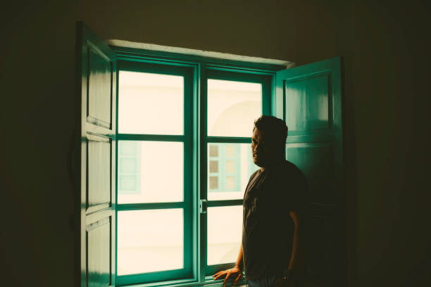 istock Asian taking In The View from His  Room 1362827741