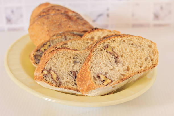 istock freshly made sourdough bread with walnuts sliced ​​on a plate on a counter 1362827827