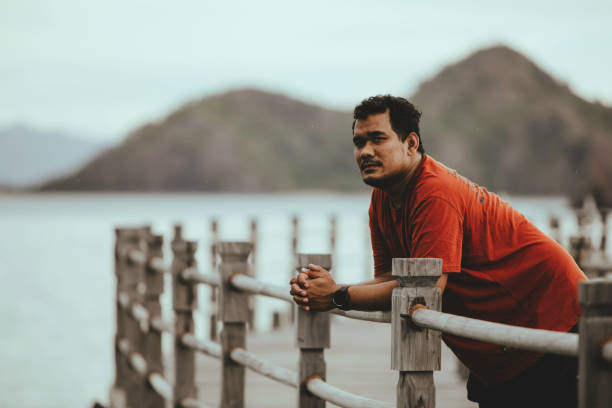 istock side view   of man standing on boardwalk 1362827856