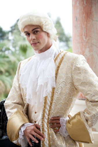 18th century themed costume shoot. Dressed In period costume the young man is posing and looking towards the camera. On location in Cannes, France at Istockalypse, Taken with Canon 5D Mark2 