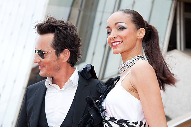 Celebrity Couple Smiling For Camera View showing a celebrity couple, looking glamorous and smiling for the camera at red carpet event. Taken at Istockalypse, Cannes, France with Canon 5D Mark2 tinted sunglasses stock pictures, royalty-free photos & images