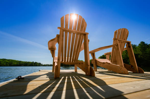 istock Sunrise on two empty Adirondack chairs sitting on a dock 1362835853